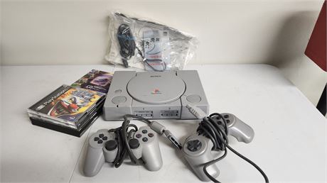 PlayStation System & 2 Controllers & Cords & 4 Games NOT TESTED
