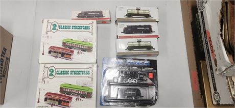 Lot of toy train cars and Street cars