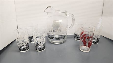 Glass Pitcher & 6 drinking Glasses. One Is A Wizard Of Oz Drinking Glass