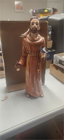 Religious Statue. Dove On His Shoulder Has One Broken Wing