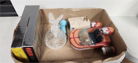 Perfume bottle and new vhs tape