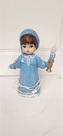 Small Child Holding A Lighted Candle