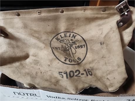 Klein tools bag filled with plumbing supplies