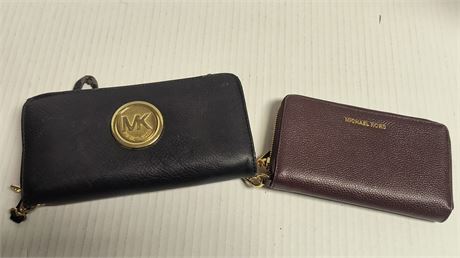 2 Michael Kors Wallets. Black Wallet Has Some Damage To It.