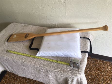 Nice wooden boat paddle and boat cushion