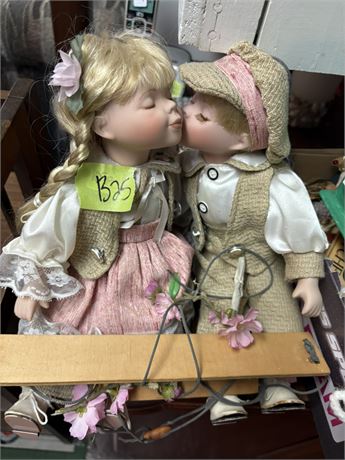 Figures Kissing on Swing